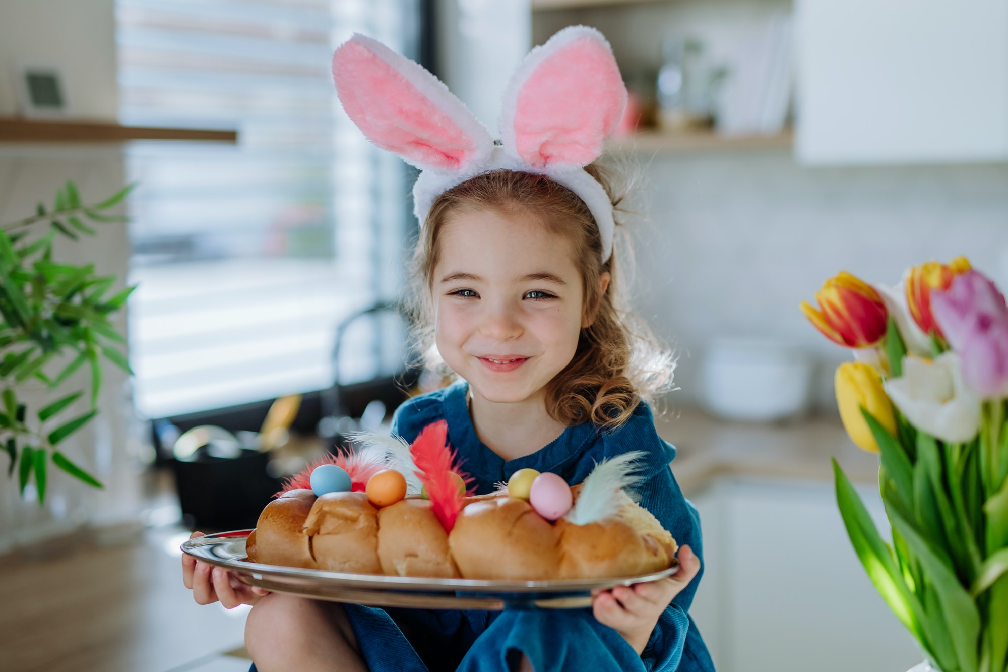 Little girl holding easter pastries, celebrating easter and spring.